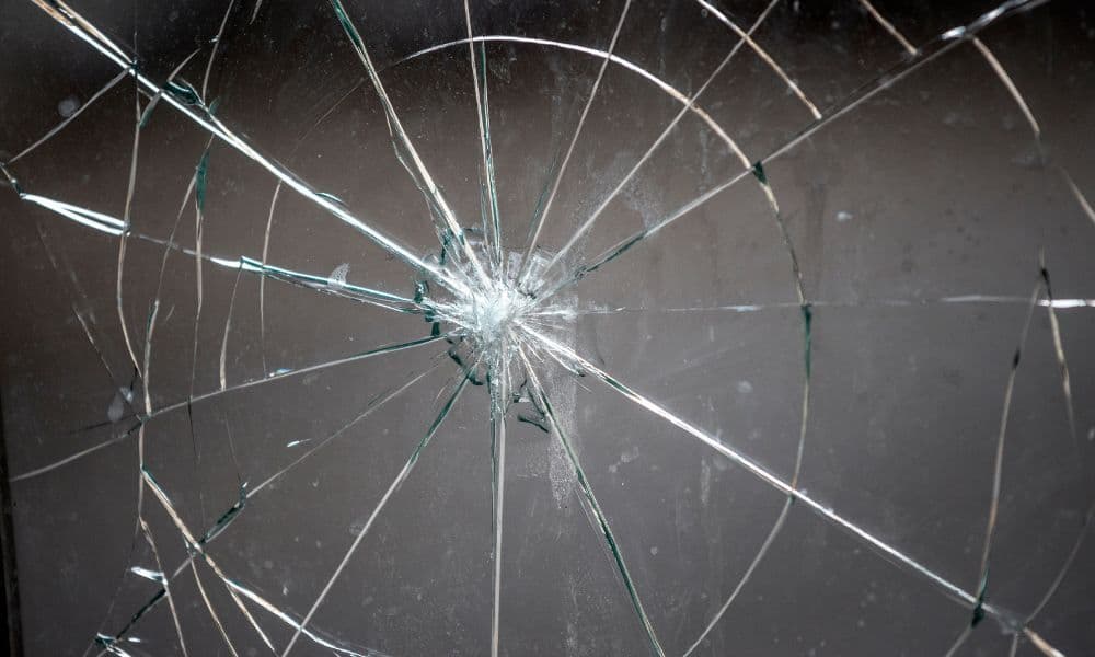 Ruitschade met spinnenwebvormige barsten in glas